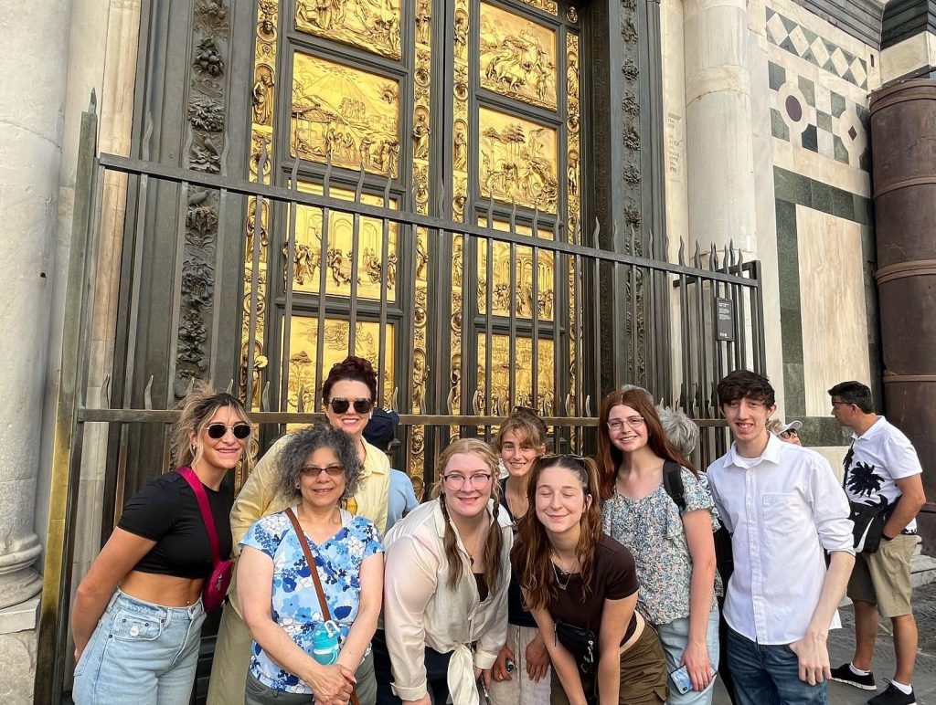 Image of a group of people posing in front of The Baptistery and the Gates of Paradise.