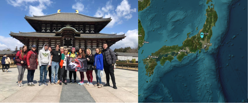 A group of people posing in front of a building with a "Indiana University East" flag next to a map of Japan.