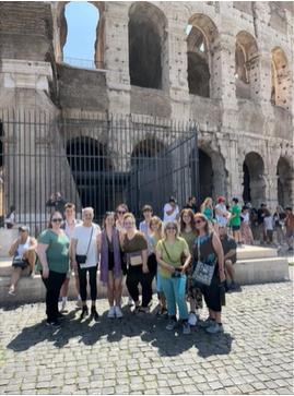 A photo of a group of people outside the colosseum.