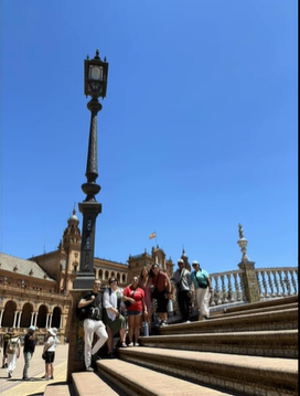 A photo of a group of people posing on steps.