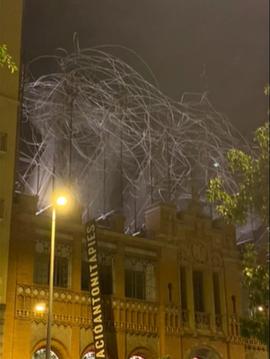 A photo of a building with a sign in Spanish.