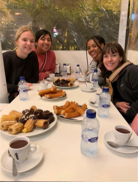 A photo of four people posing at a table.