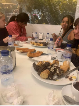 A photo of four people eating at a table.