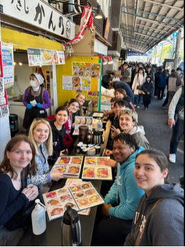 A photo of a group of people posing at a table.