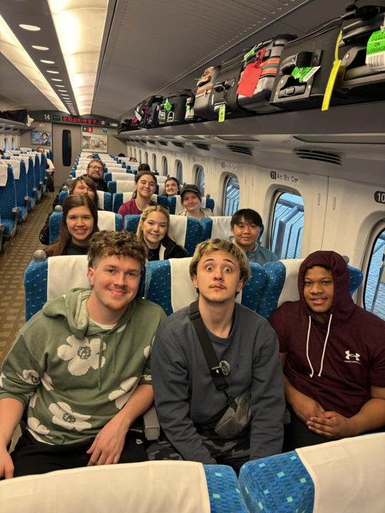 Image of a group of people posing on a train.