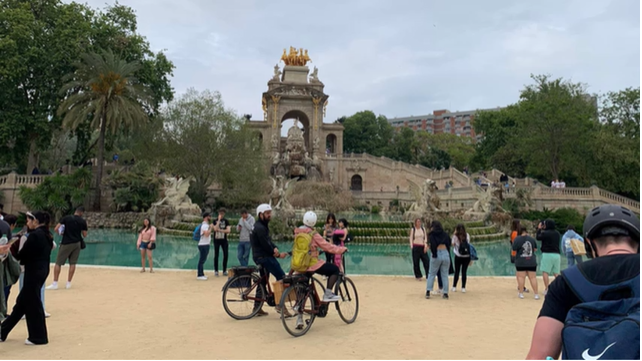 A photo of people looking at a fountain.