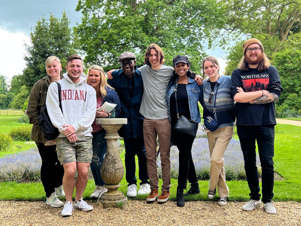 A photo of a group of people posing outdoors.