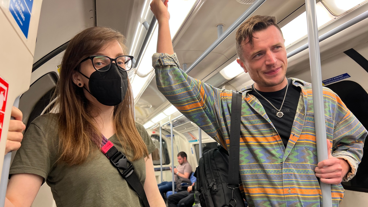 A photo of two people on the tube.