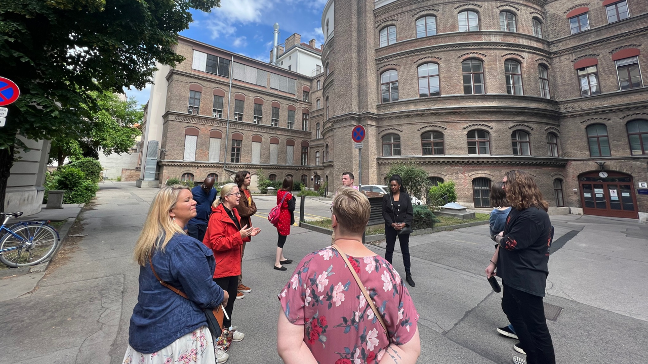 A photo of a group of people on a walking tour.