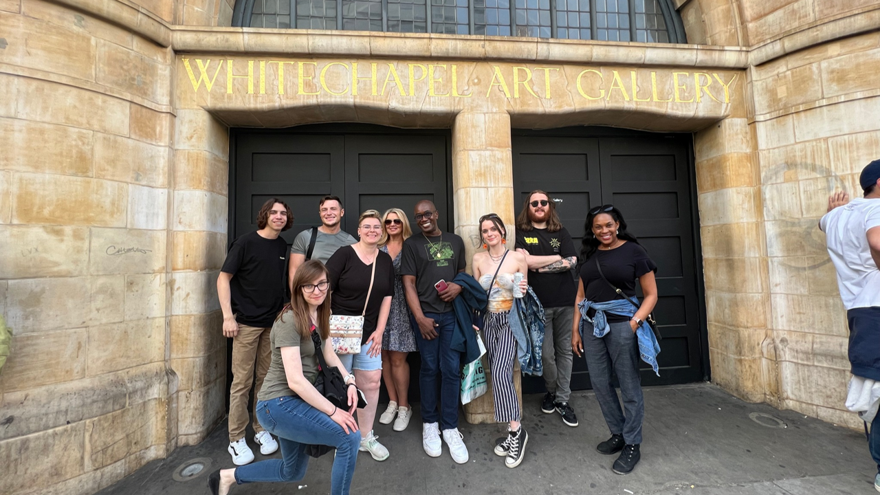 A photo of a group of people posing outside of the Whitechapel Art Gallery.