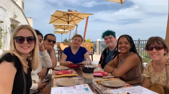 A photo of a group of people posing at a table.