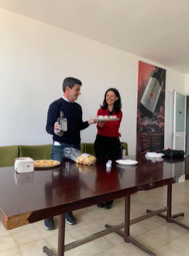 A photo of two people with food samples.