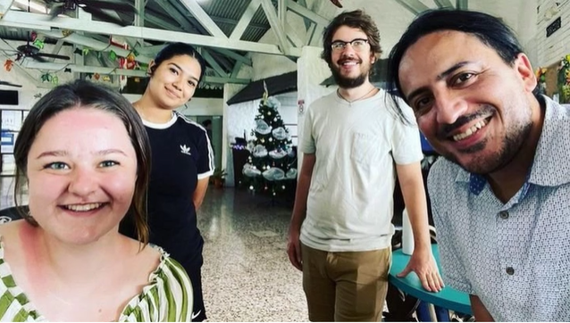 A photo of a group of people posing for a selfie.