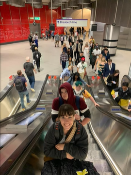 A photo of people on escalators in an airport.