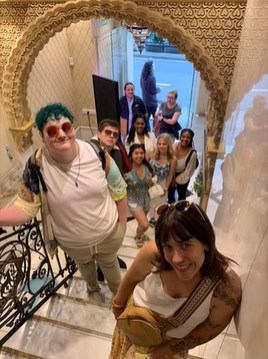 A photo of a group of people standing on a Spanish staircase.