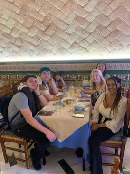 A photo of a group of people posing at a table.