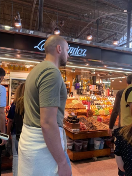 A photo of people walking around a market.