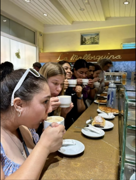 A photo of a group of people drinking coffee.