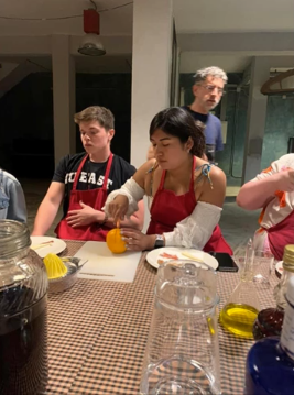 A photo of four people cooking.