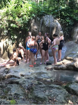 A photo of a group of people swimming in a cove.