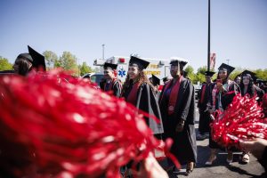 Graduates walk through a cheer tunnel during the IU Northwest Commencement.