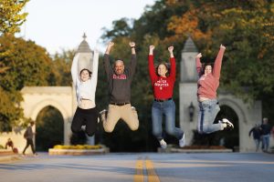 IU fans posing for a photo in front of Sample Gates.