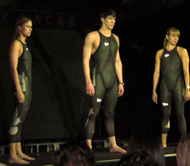 Three swimmers with are each wearing an L Z R Racer Suit, which is a swimsuit composed of elastane nylon and polyurethane. The seams of the suit are ultrasonically welded to reduce drag.
