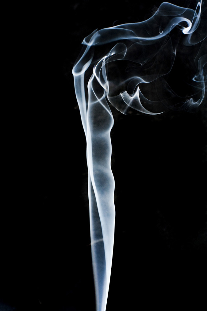 Photograph of smoke rising smoothly for a while and then beginning to form swirls and eddies.