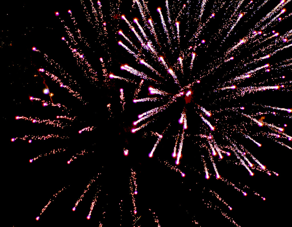 A photograph of a fireworks display in the sky.