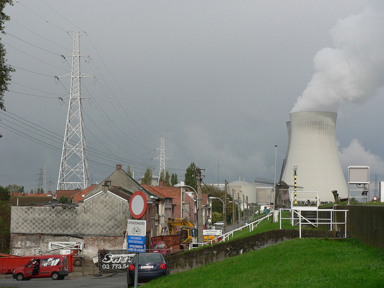 The image shows people living in their homes located near a nuclear power plant.