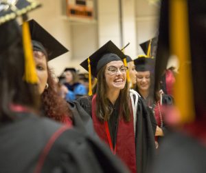 IU Columbus graduate smiles at friends before Commencement.