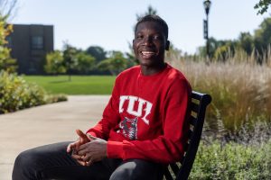 Image of an IU East student sitting outside.