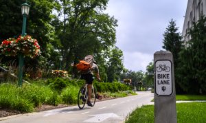 A cyclist pedaling through campus at IU Bloomington.