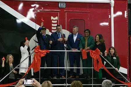 Left to right: Amy Sams, Michele Saysana, MD; Kelvin Lee, MD; Nasser Hanna, MD; John Wood; Virginia Caine, MD; Nichole Wilson; and Jami Marsh attend a ribbon cutting for the mobile health unit on March 4, 2025. | Photo by Mika Mokko, IU Simon Comprehensive Cancer Center