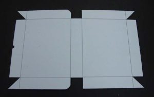 Piece of corrugated board with excess material cut away