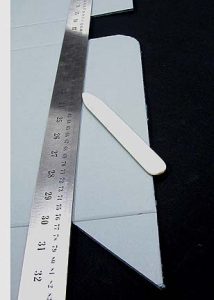 Making a crease with a straight edge and bone folder
