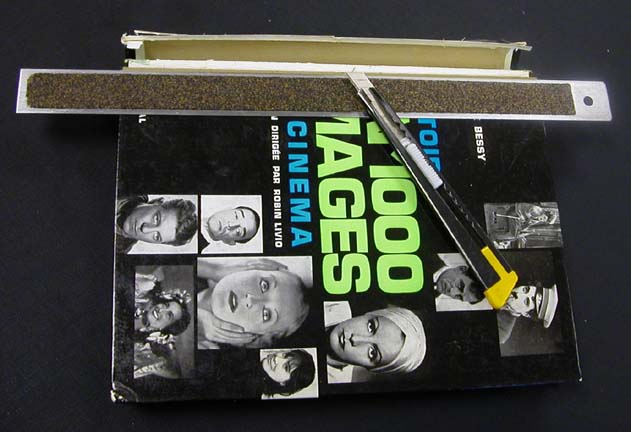 Cutting the cover cloth to remove the spine cover