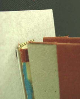 Positioning the new spine cloth for the reback