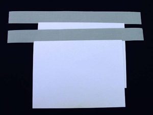 Strips of hinge cloth adhered to endsheets