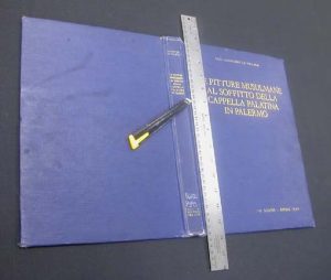 Cutting the book cloth parallel to the spine 1/8" in from board edge