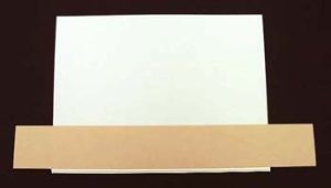 Masking the edge of the endsheets in preparation for applying adhesive