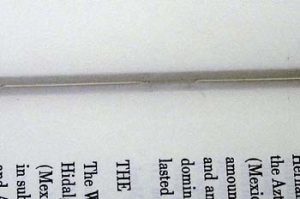 Close up of stitches in a sewn-through-the fold signature