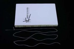 Text block and a piece of thread 5 times its length