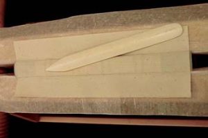 Adhering the spine lining and rubbing it down with a bone folder