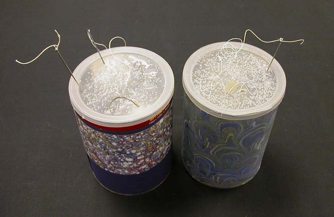 Sewing needles stuck in a coffee can lid