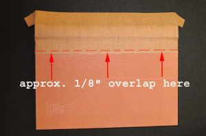 Positioning the new spine cover on the board