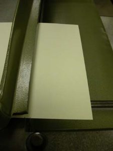Using the edge of the board shear table to make a crease