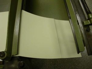 Third crease made on the board shear