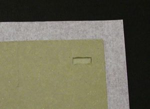 Board covered with cloth after tie hole has been made