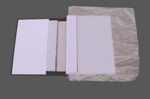 Waxed paper inserted after spine lining extensions are glued